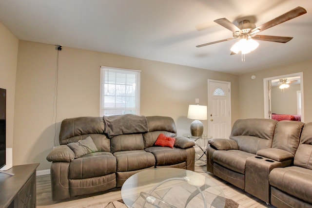 living room featuring light hardwood / wood-style flooring and ceiling fan