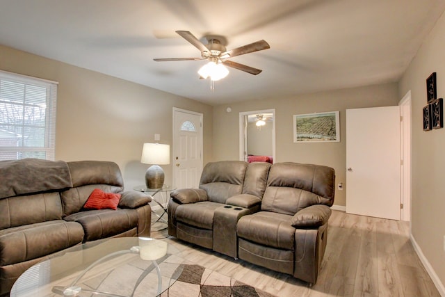 living room featuring light wood-type flooring and ceiling fan