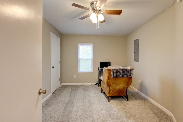 living area featuring ceiling fan, electric panel, and light carpet