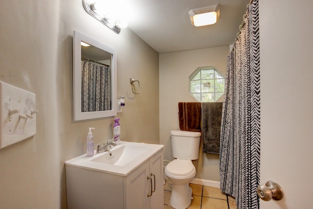 bathroom with toilet, tile patterned flooring, and vanity