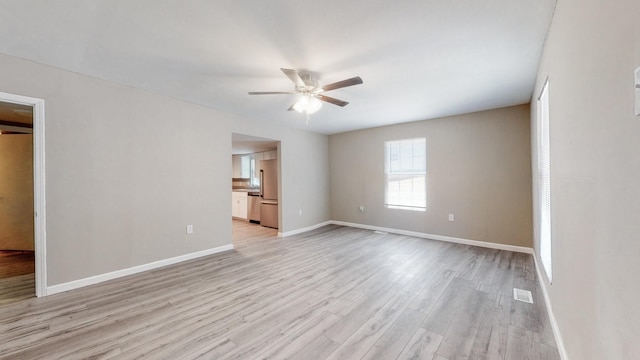 unfurnished room featuring light hardwood / wood-style flooring and ceiling fan