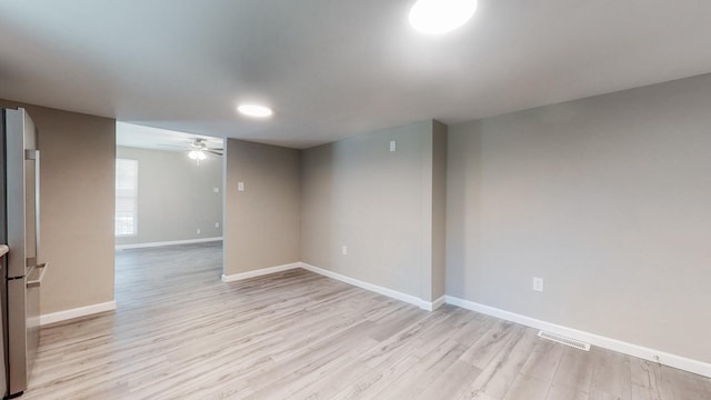 spare room with light hardwood / wood-style floors and ceiling fan