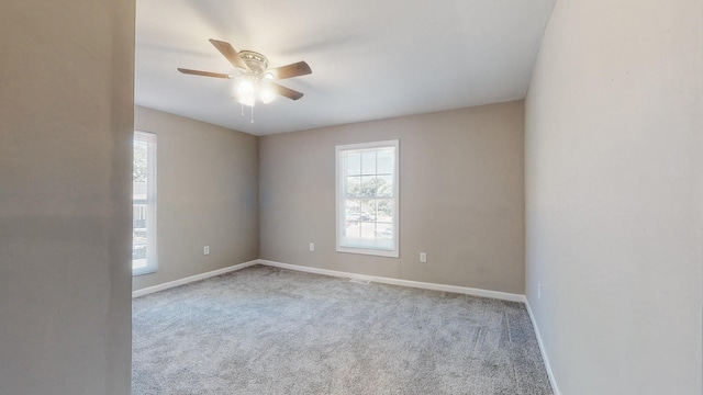 empty room with ceiling fan and light carpet