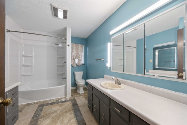 full bathroom with vanity, tile patterned floors, washtub / shower combination, toilet, and a textured ceiling