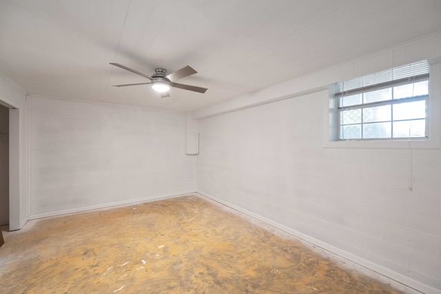 empty room with ceiling fan and concrete floors