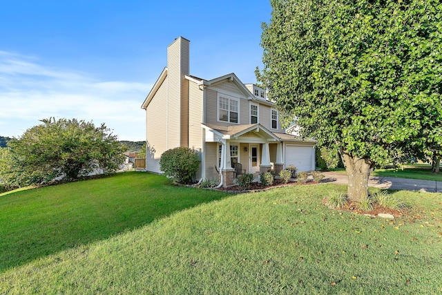 view of front of home with a front yard and a garage