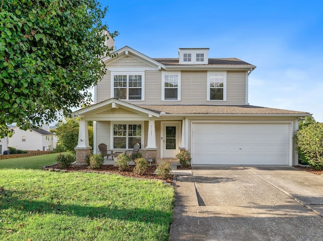 view of front of home with a garage, covered porch, and a front lawn