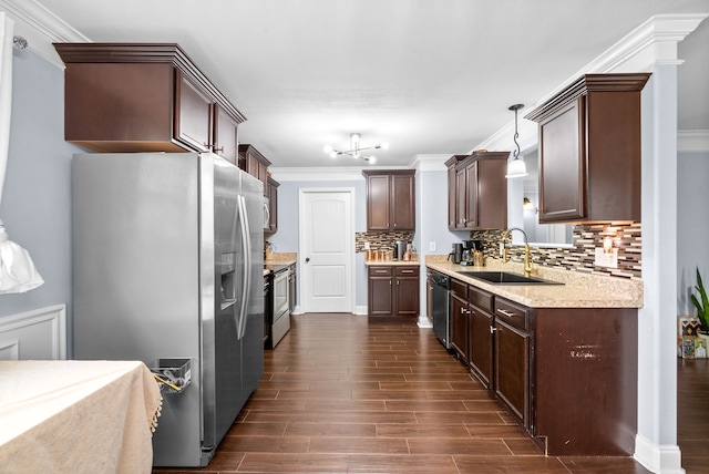 kitchen featuring pendant lighting, decorative backsplash, sink, and stainless steel appliances