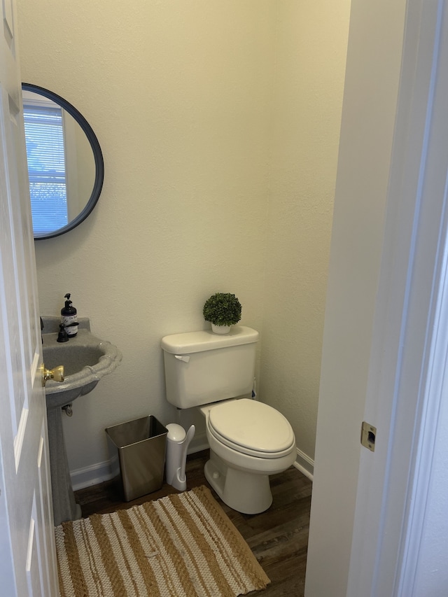 bathroom featuring hardwood / wood-style floors and toilet