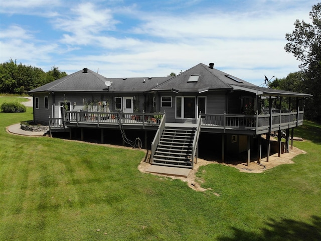 back of house with a lawn and a deck