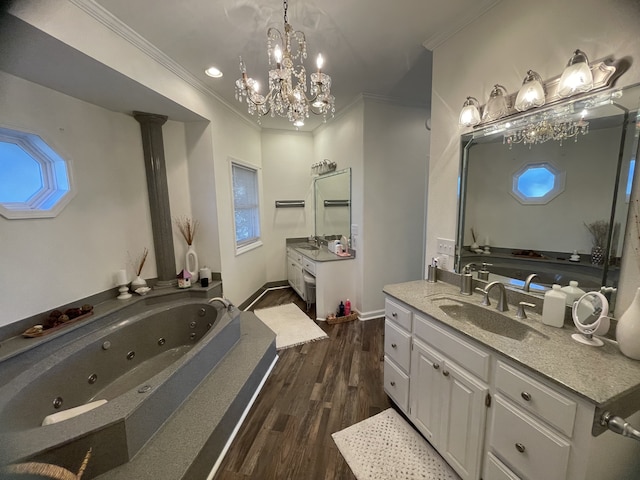 bathroom featuring ornate columns, a bath, crown molding, hardwood / wood-style floors, and vanity