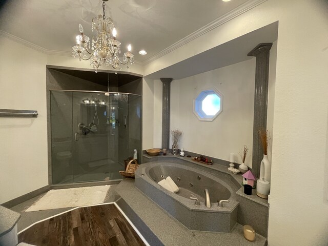 bathroom with plus walk in shower, an inviting chandelier, hardwood / wood-style flooring, ornamental molding, and ornate columns