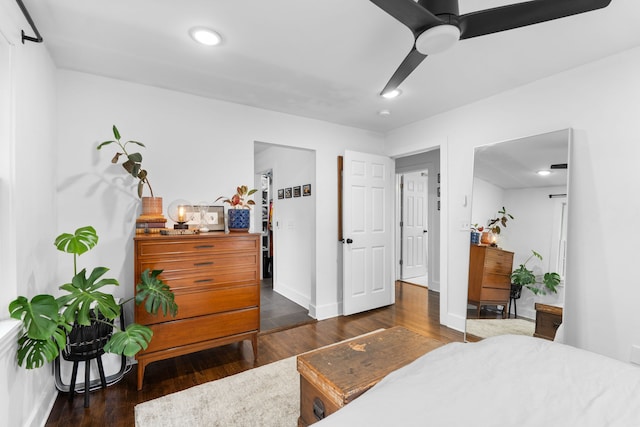 bedroom with dark hardwood / wood-style floors and ceiling fan