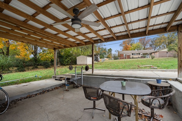 view of patio with ceiling fan and a shed