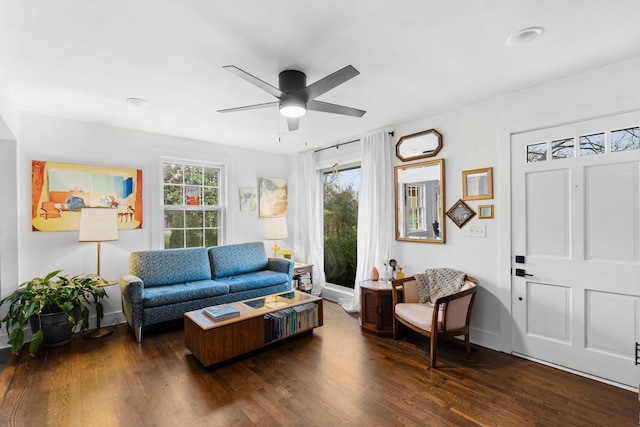 living room featuring ceiling fan and dark hardwood / wood-style floors