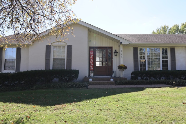 ranch-style home with a front lawn