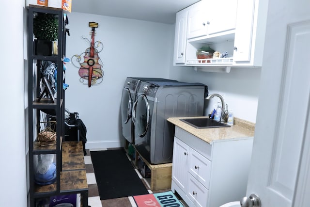 laundry room with cabinets, sink, and washing machine and dryer