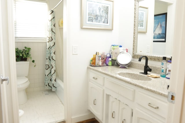 full bathroom with tile patterned flooring, vanity, toilet, and shower / tub combo