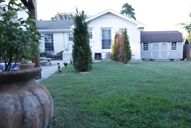 exterior space with a patio area, a shed, and a front yard