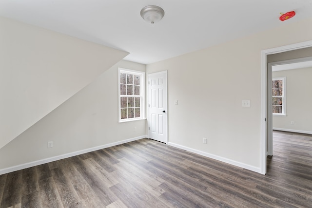 empty room featuring dark wood-type flooring