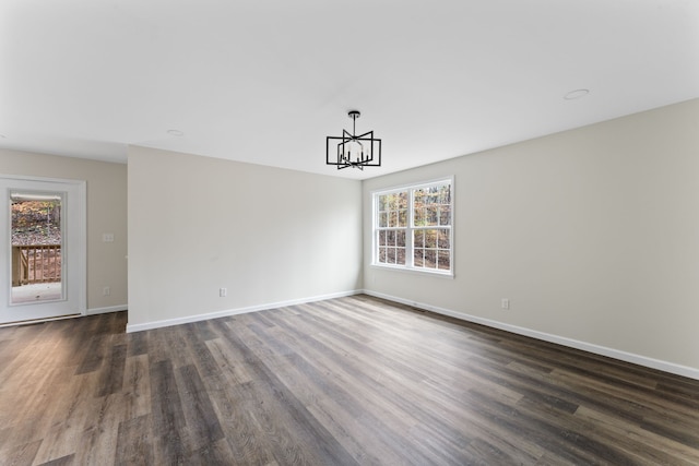 unfurnished dining area featuring dark hardwood / wood-style floors and a notable chandelier