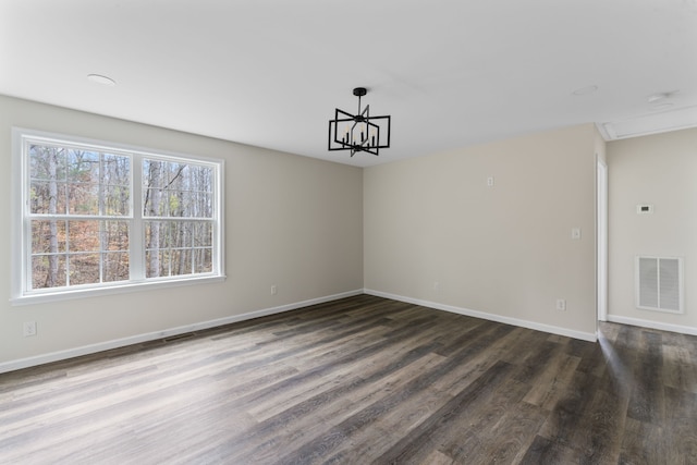 unfurnished dining area with a chandelier and wood-type flooring