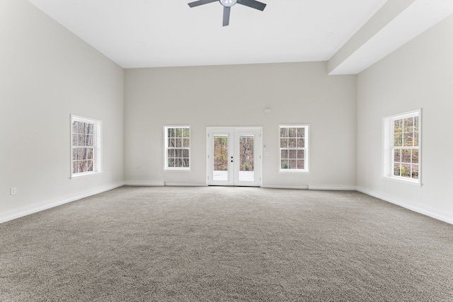 unfurnished living room featuring carpet flooring, french doors, plenty of natural light, and ceiling fan