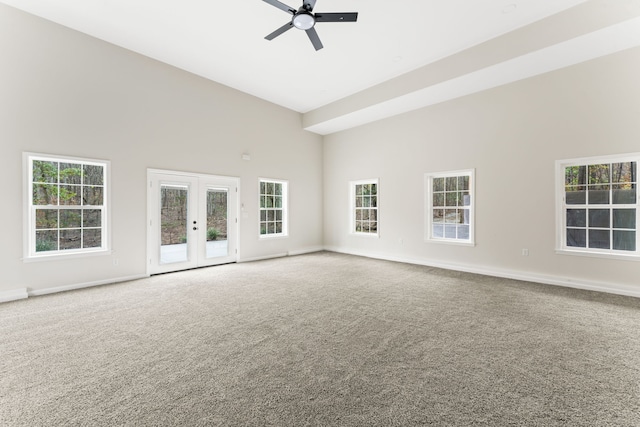 unfurnished room with carpet flooring, french doors, high vaulted ceiling, and ceiling fan