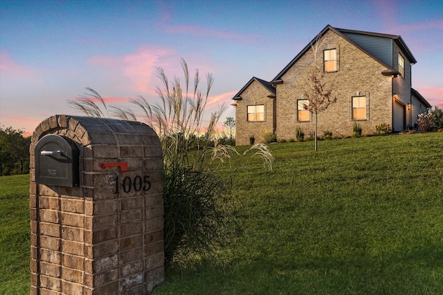 view of front of property featuring a lawn and a garage