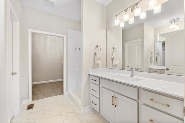 bathroom with vanity and a shower