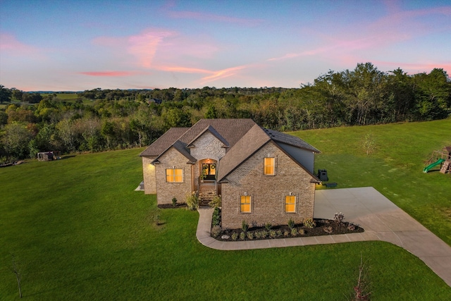 french country home with a lawn