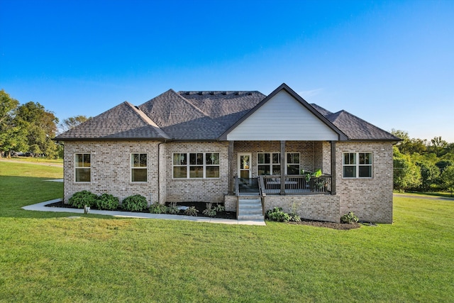 view of front of home with covered porch and a front lawn