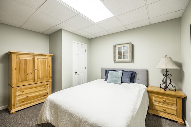 carpeted bedroom with a drop ceiling