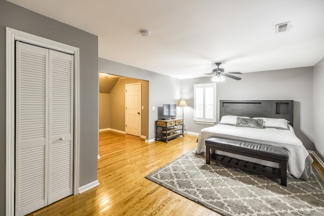 bedroom with wood-type flooring, a closet, and ceiling fan