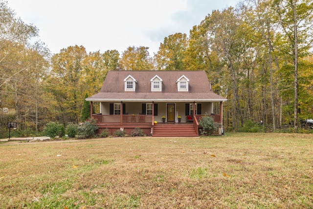 cape cod-style house with covered porch and a front yard