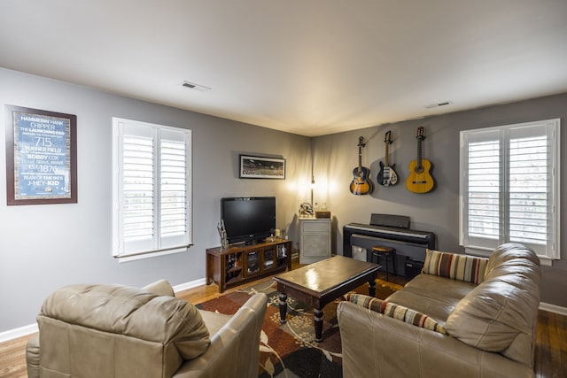 living room with plenty of natural light and hardwood / wood-style flooring