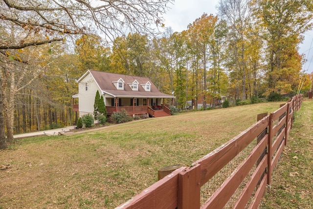 exterior space with covered porch and a front yard