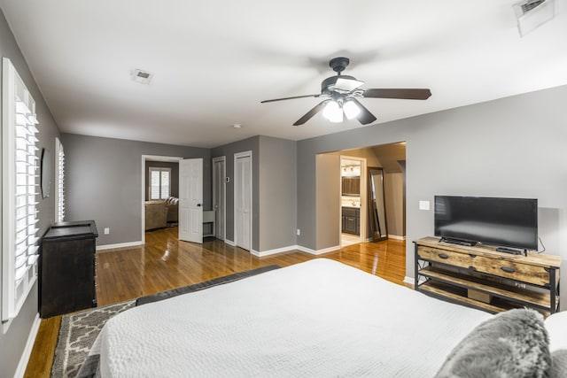 bedroom featuring ensuite bathroom, ceiling fan, and dark wood-type flooring