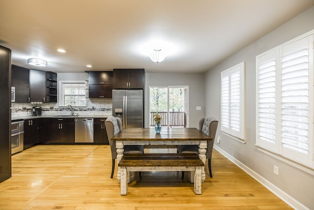 dining room featuring light wood-type flooring and sink