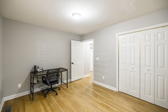 office area with light hardwood / wood-style floors