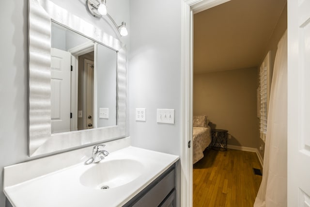 bathroom with hardwood / wood-style flooring and vanity