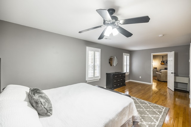 bedroom featuring dark hardwood / wood-style floors and ceiling fan