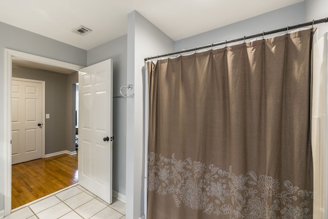 bathroom with hardwood / wood-style flooring