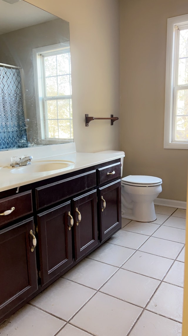 bathroom with tile patterned flooring, vanity, and toilet