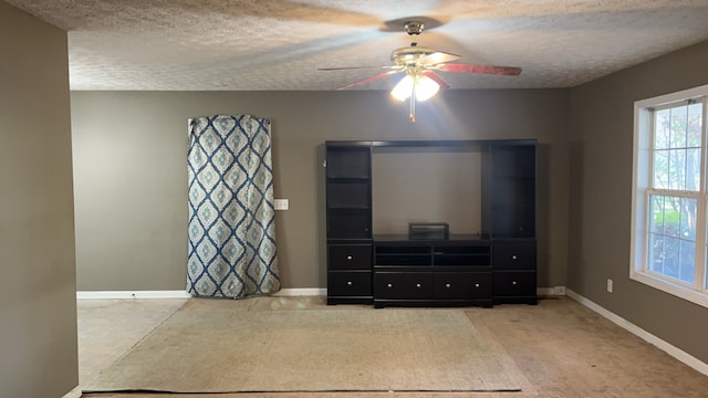 living room with carpet flooring, a textured ceiling, and ceiling fan