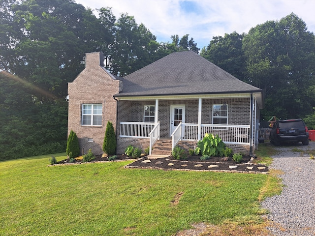 view of front of home with covered porch and a front lawn