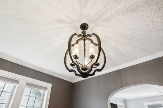 details with a textured ceiling and ornamental molding