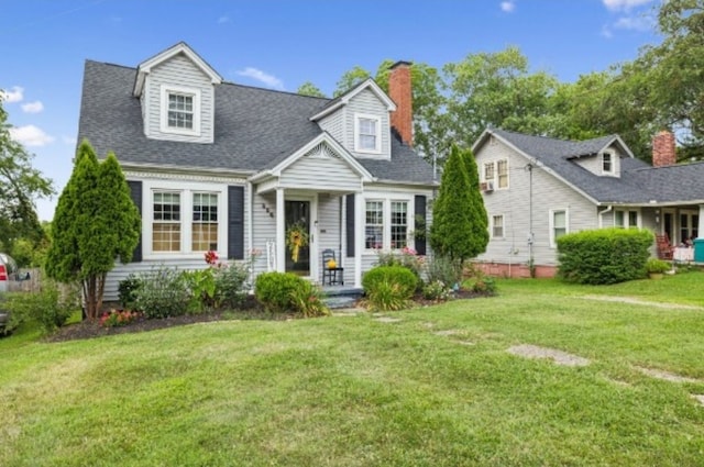 cape cod-style house with a front lawn