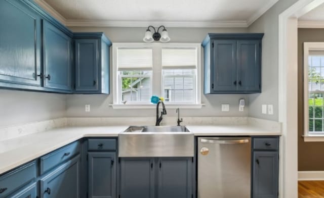 kitchen featuring stainless steel dishwasher, sink, ornamental molding, and blue cabinetry