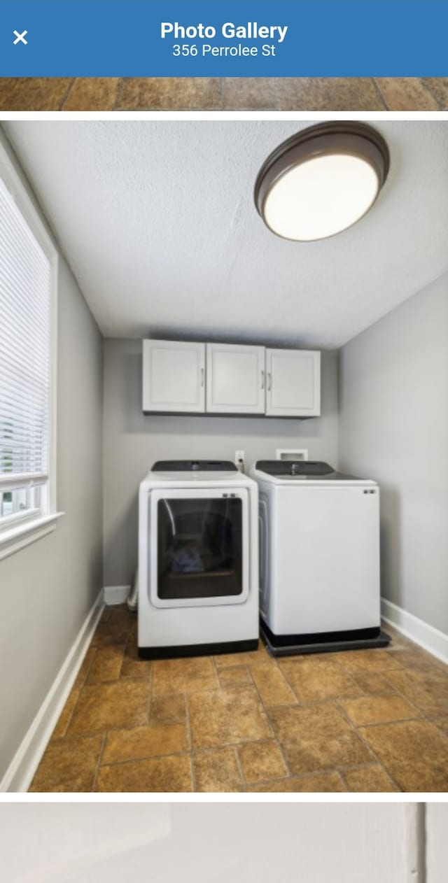 clothes washing area featuring cabinets and washing machine and dryer